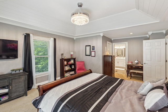 bedroom featuring a chandelier, connected bathroom, ornamental molding, carpet floors, and a tray ceiling