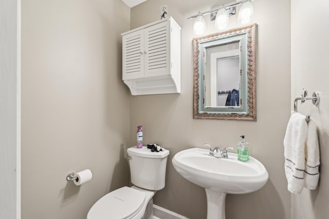 bathroom with toilet and a sink