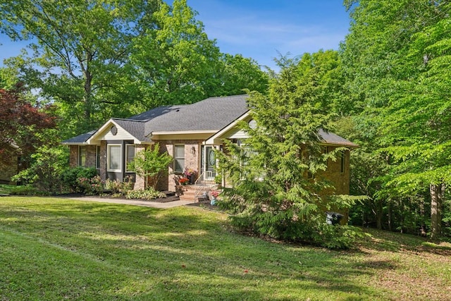 ranch-style house featuring brick siding and a front yard