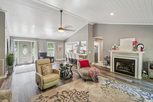 living room with baseboards, a ceiling fan, wood finished floors, lofted ceiling, and a fireplace