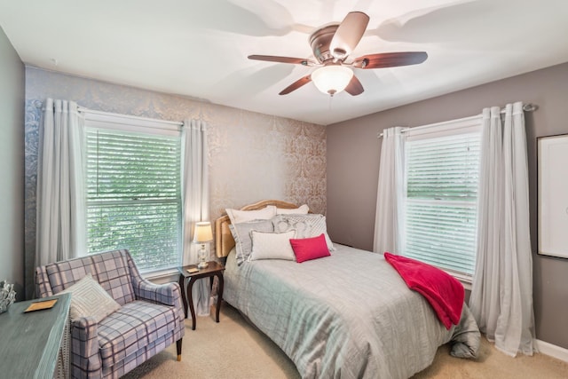 bedroom with light carpet and a ceiling fan