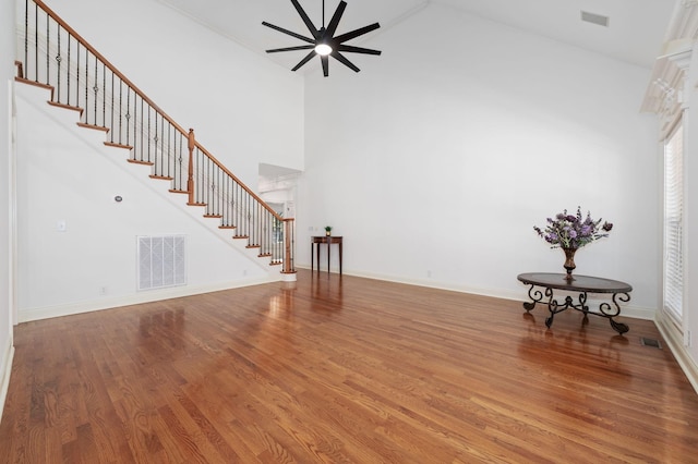5417 Cavendish Dr, Murfreesboro, TN 37128 - unfurnished living room featuring stairway, ceiling fan, wood finished floors, a high ceiling, and baseboards