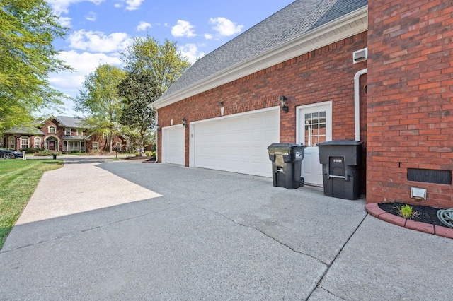 5417 Cavendish Dr, Murfreesboro, TN 37128 - view of side of property with driveway, a shingled roof, brick siding, and an attached garage