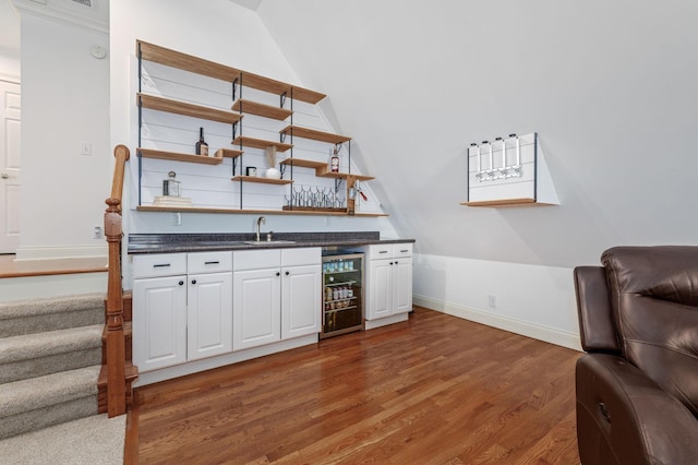 5417 Cavendish Dr, Murfreesboro, TN 37128 - indoor wet bar featuring wood finished floors, baseboards, beverage cooler, lofted ceiling, and stairs