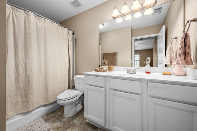 full bathroom with toilet, vanity, shower / tub combo, and stone finish flooring