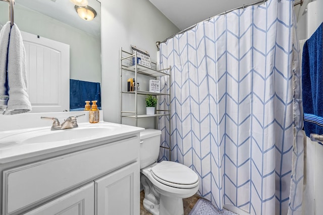 bathroom featuring vanity, toilet, and a shower with curtain