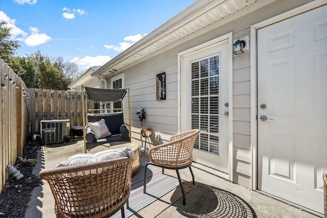 view of patio / terrace featuring cooling unit, fence, and outdoor lounge area