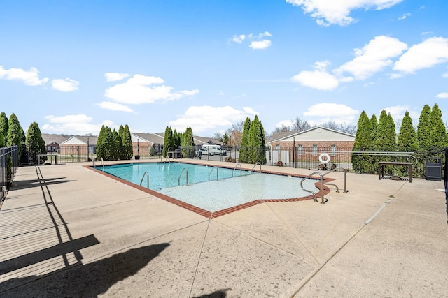 community pool with fence and a patio area