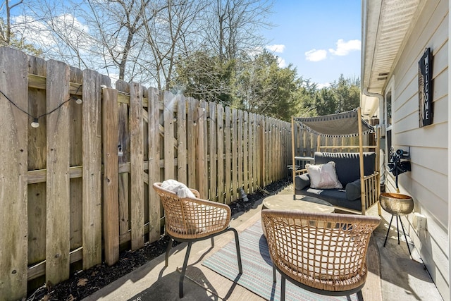 view of patio featuring outdoor lounge area and a fenced backyard
