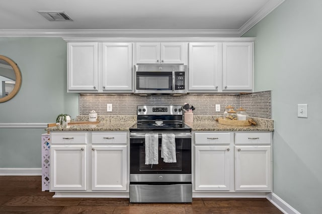 kitchen with appliances with stainless steel finishes, ornamental molding, white cabinets, baseboards, and light stone countertops