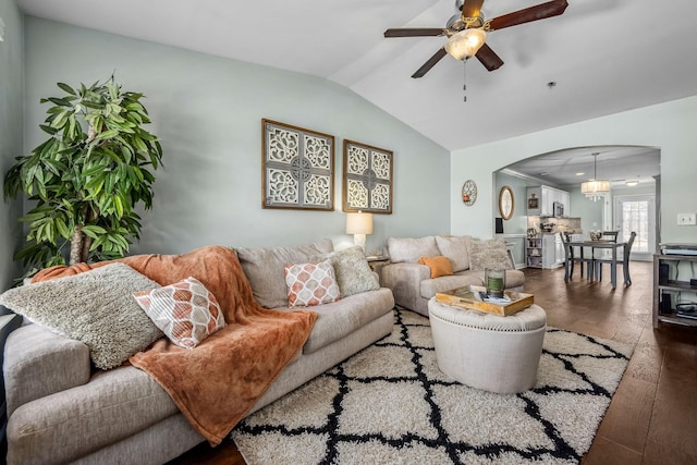 living area featuring arched walkways, wood-type flooring, lofted ceiling, and ceiling fan
