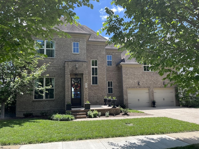 traditional home featuring a front lawn, concrete driveway, brick siding, and an attached garage