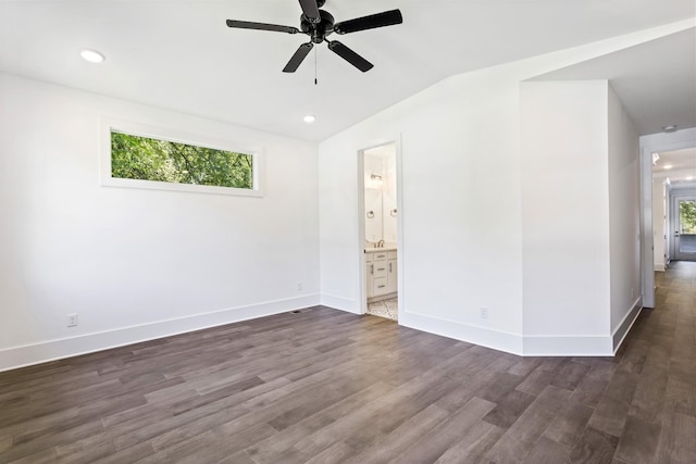 empty room with ceiling fan, lofted ceiling, dark wood-style floors, baseboards, and recessed lighting