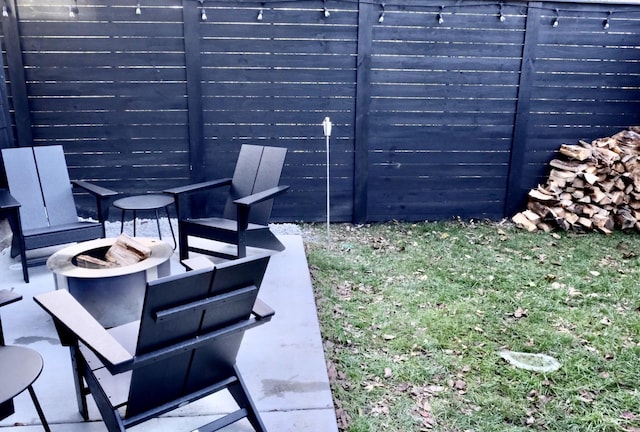 view of yard featuring a fire pit and a patio area