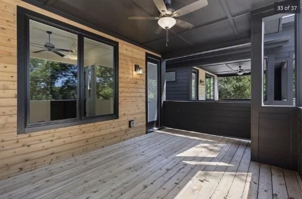 wooden terrace featuring a ceiling fan