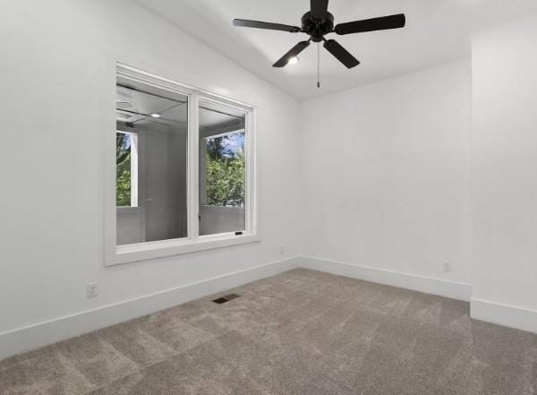 unfurnished room featuring carpet flooring, baseboards, and a ceiling fan