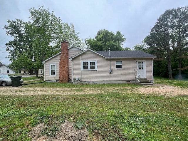 108 Butler Speedway, Bruceton, TN 38317 - rear view of property featuring entry steps, crawl space, a yard, and a chimney