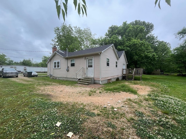 108 Butler Speedway, Bruceton, TN 38317 - rear view of house featuring a chimney, entry steps, a yard, and a wooden deck
