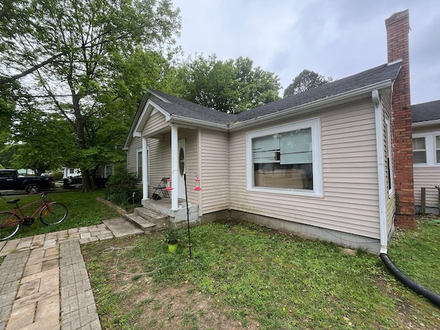 108 Butler Speedway, Bruceton, TN 38317 - view of property exterior with a chimney and a yard