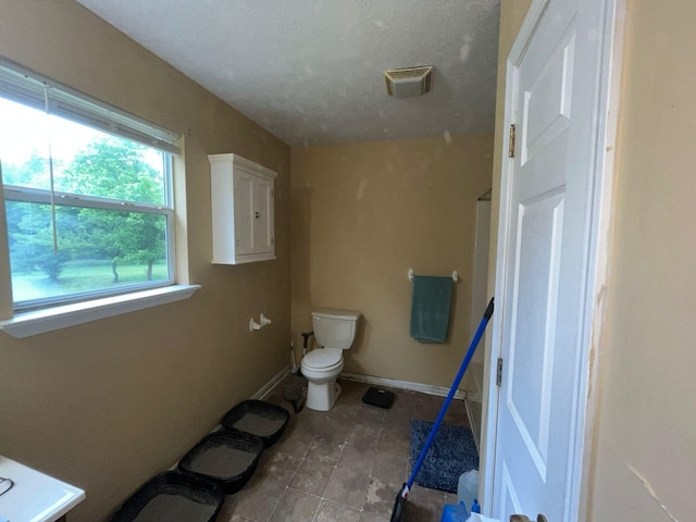 108 Butler Speedway, Bruceton, TN 38317 - bathroom featuring toilet, baseboards, and tile patterned floors
