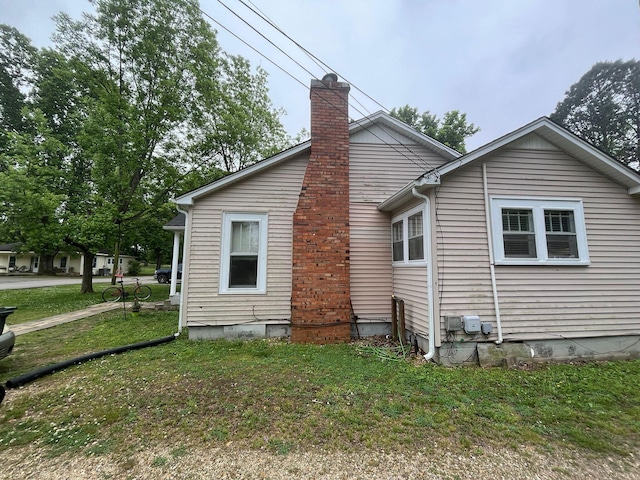 108 Butler Speedway, Bruceton, TN 38317 - view of side of home with a chimney and a yard