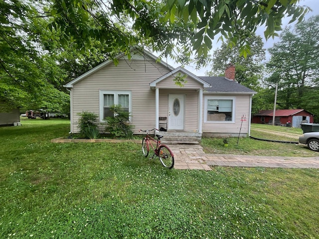 108 Butler Speedway, Bruceton, TN 38317 - bungalow-style house featuring a chimney and a front lawn