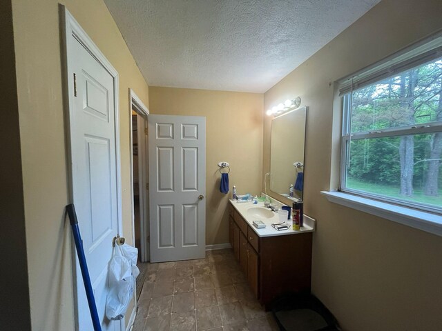 108 Butler Speedway, Bruceton, TN 38317 - bathroom with a textured ceiling, vanity, and baseboards