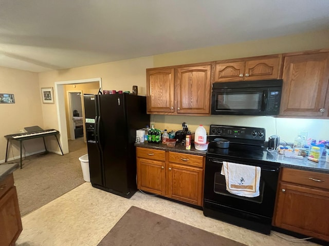 108 Butler Speedway, Bruceton, TN 38317 - kitchen featuring black appliances, dark countertops, brown cabinets, and light colored carpet
