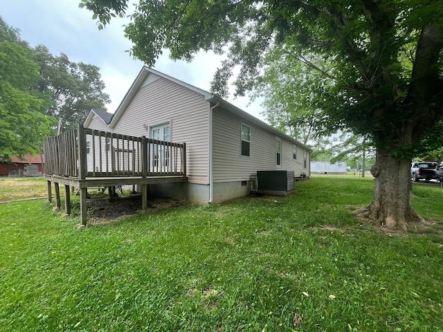 108 Butler Speedway, Bruceton, TN 38317 - rear view of house with a wooden deck, a lawn, and central air condition unit