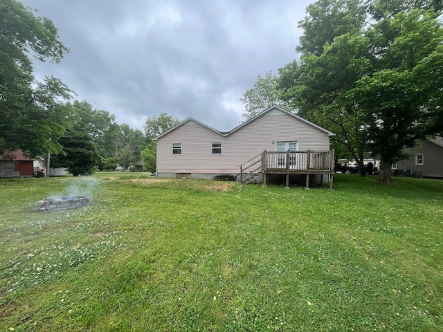 108 Butler Speedway, Bruceton, TN 38317 - back of property with a deck and a lawn