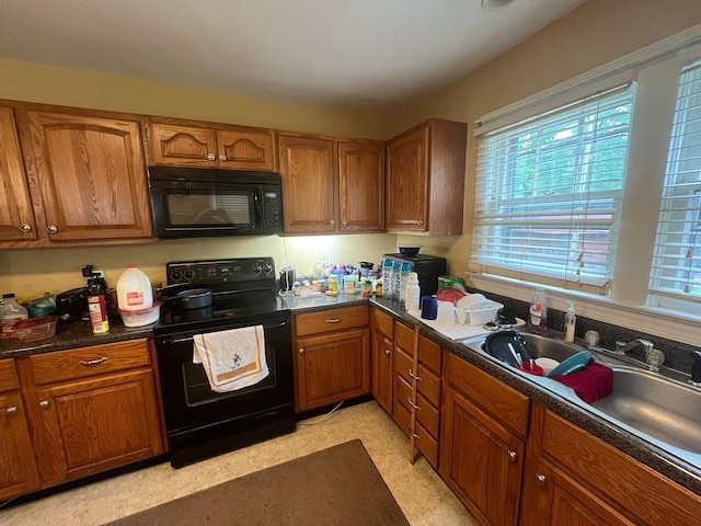 108 Butler Speedway, Bruceton, TN 38317 - kitchen with black appliances, brown cabinets, plenty of natural light, and dark countertops
