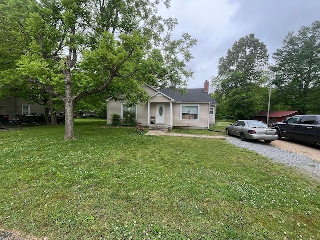 108 Butler Speedway, Bruceton, TN 38317 - bungalow-style house featuring a chimney and a front lawn