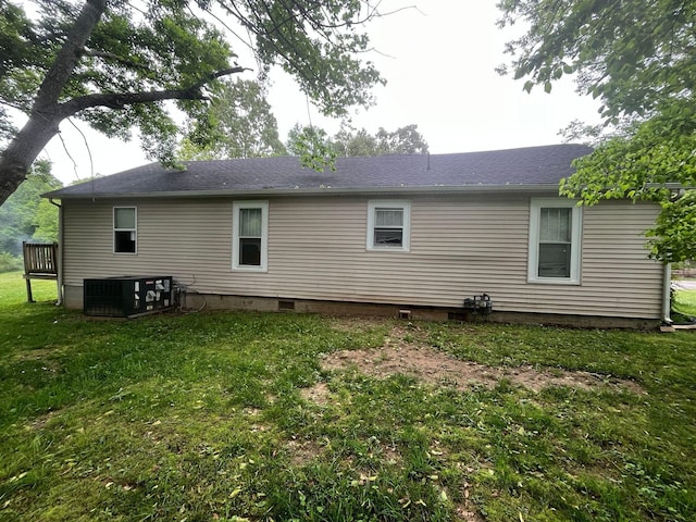 108 Butler Speedway, Bruceton, TN 38317 - rear view of property featuring central AC, a yard, and a shingled roof