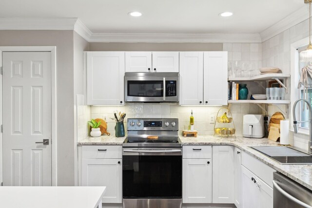 906 Temple Ct, Murfreesboro, TN 37130 - kitchen with appliances with stainless steel finishes, open shelves, white cabinets, ornamental molding, and recessed lighting