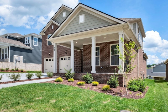 view of front of home featuring brick siding, a porch, a front yard, and concrete driveway