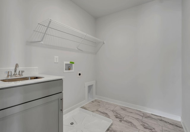 clothes washing area featuring electric dryer hookup, cabinet space, light marble finish flooring, hookup for a washing machine, and baseboards