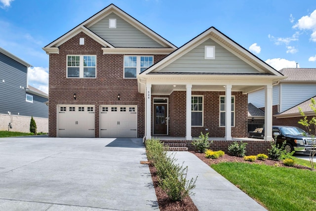 view of front of home with a porch, brick siding, driveway, and an attached garage