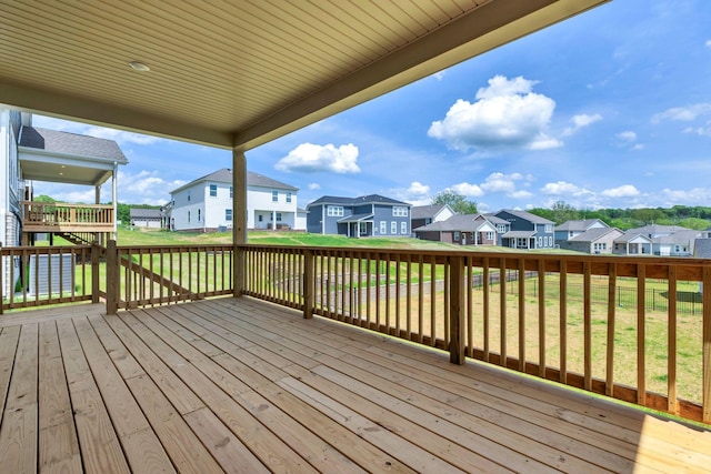 deck featuring a residential view and a yard