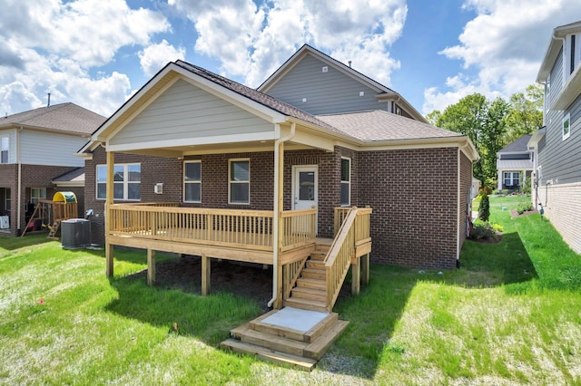 rear view of house with a wooden deck, brick siding, a lawn, stairway, and central air condition unit