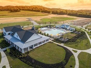 aerial view at dusk of view of pool