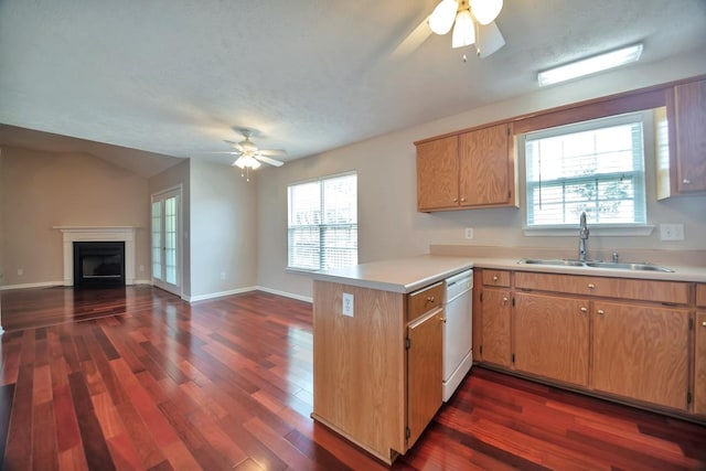 kitchen with a ceiling fan, a peninsula, a sink, open floor plan, and dishwasher