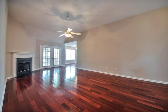 unfurnished living room featuring dark wood-type flooring, baseboards, a ceiling fan, french doors, and lofted ceiling