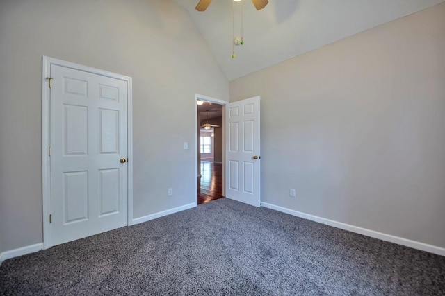 unfurnished bedroom with carpet, baseboards, a ceiling fan, and high vaulted ceiling