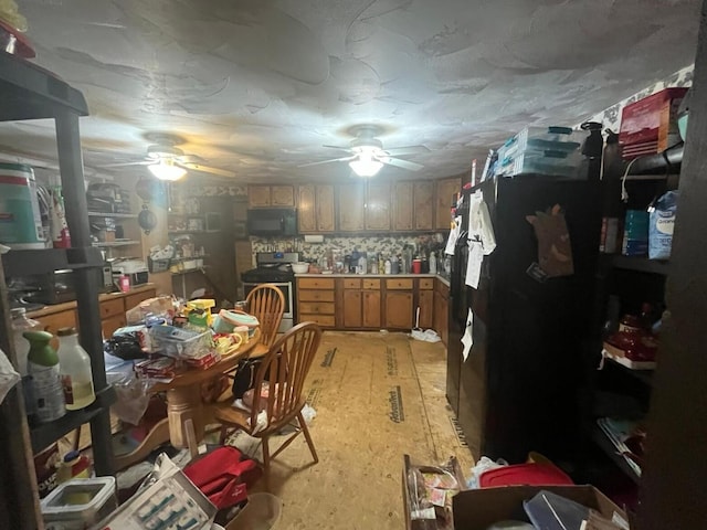 170 Keystone, Morris Chapel, TN 38361 - kitchen with gas range, black microwave, ceiling fan, and brown cabinets