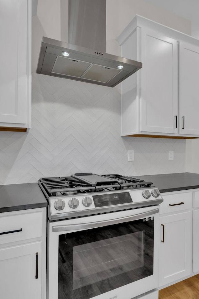 513 Perrin Aly, Antioch, TN 37013 - kitchen featuring gas range, wall chimney range hood, dark countertops, and backsplash
