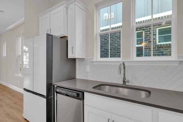 513 Perrin Aly, Antioch, TN 37013 - kitchen with stainless steel dishwasher, a sink, tasteful backsplash, and white cabinetry