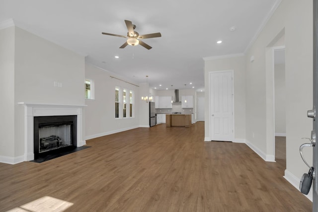 513 Perrin Aly, Antioch, TN 37013 - unfurnished living room featuring crown molding, a ceiling fan, wood finished floors, baseboards, and a fireplace with flush hearth