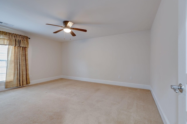 empty room with light carpet, ceiling fan, and baseboards