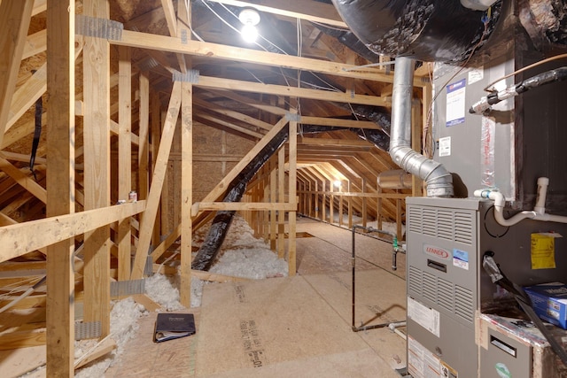 unfinished attic featuring heating unit