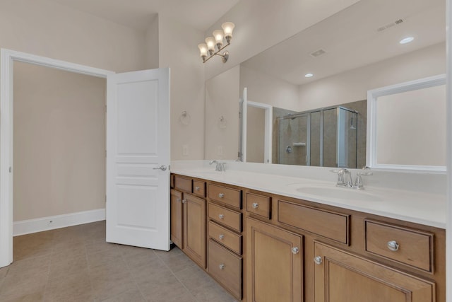 bathroom with a shower stall, double vanity, and tile patterned flooring